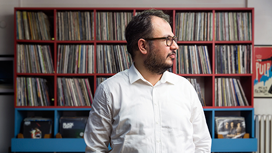 Murat Abbas with a section of his record collection